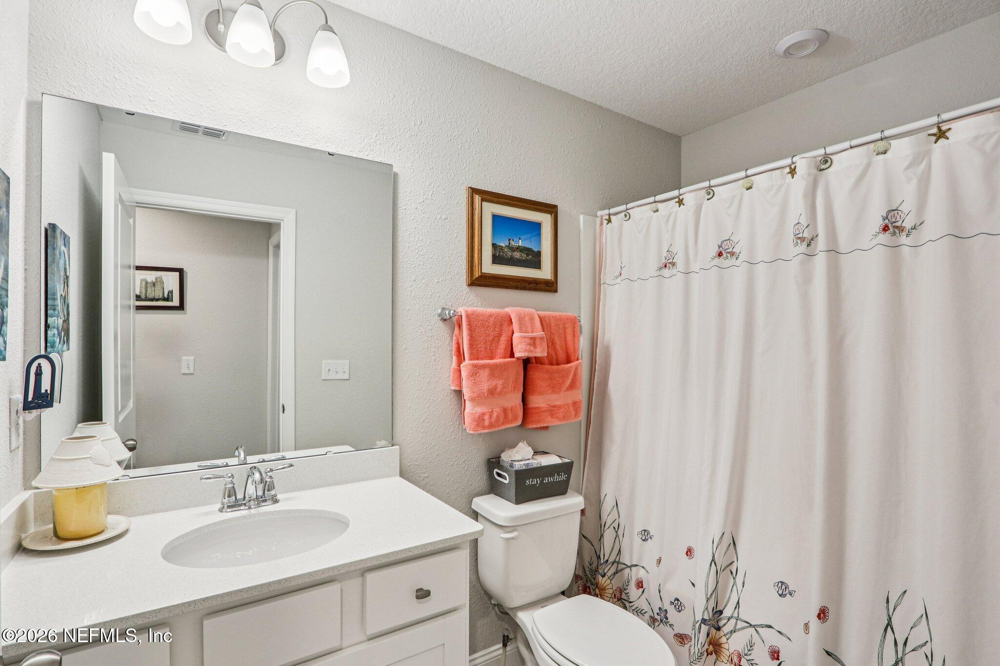 12068 Calvesta Street Jacksonville, FL 32256 - Photo 34 of 100 a bathroom with a sink vanity mirror and toilet