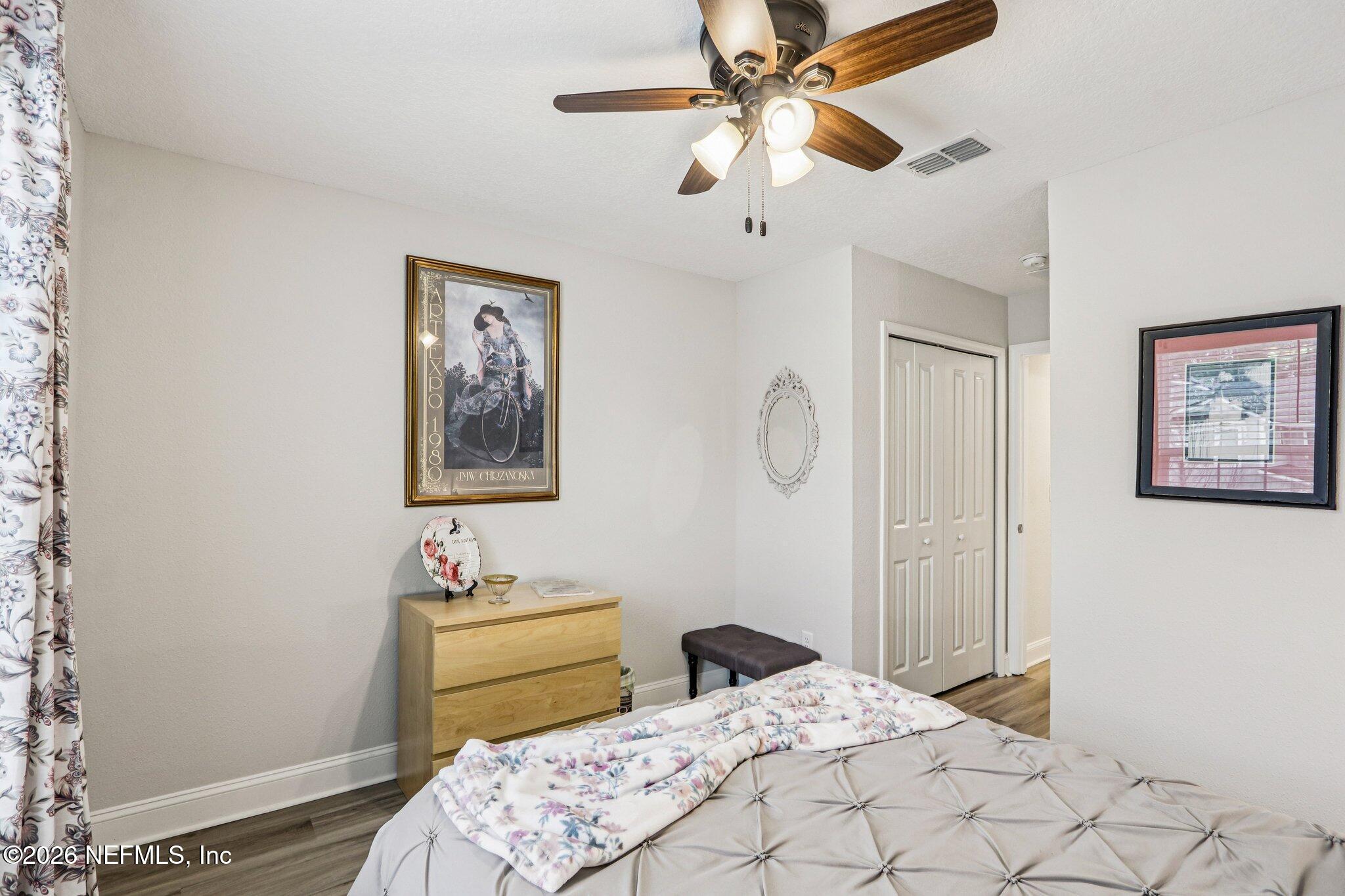 12068 Calvesta Street Jacksonville, FL 32256 - Photo 37 of 100 a bedroom with a bed and a chandelier