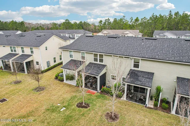 a view of a swimming pool with a bench and lawn chairs