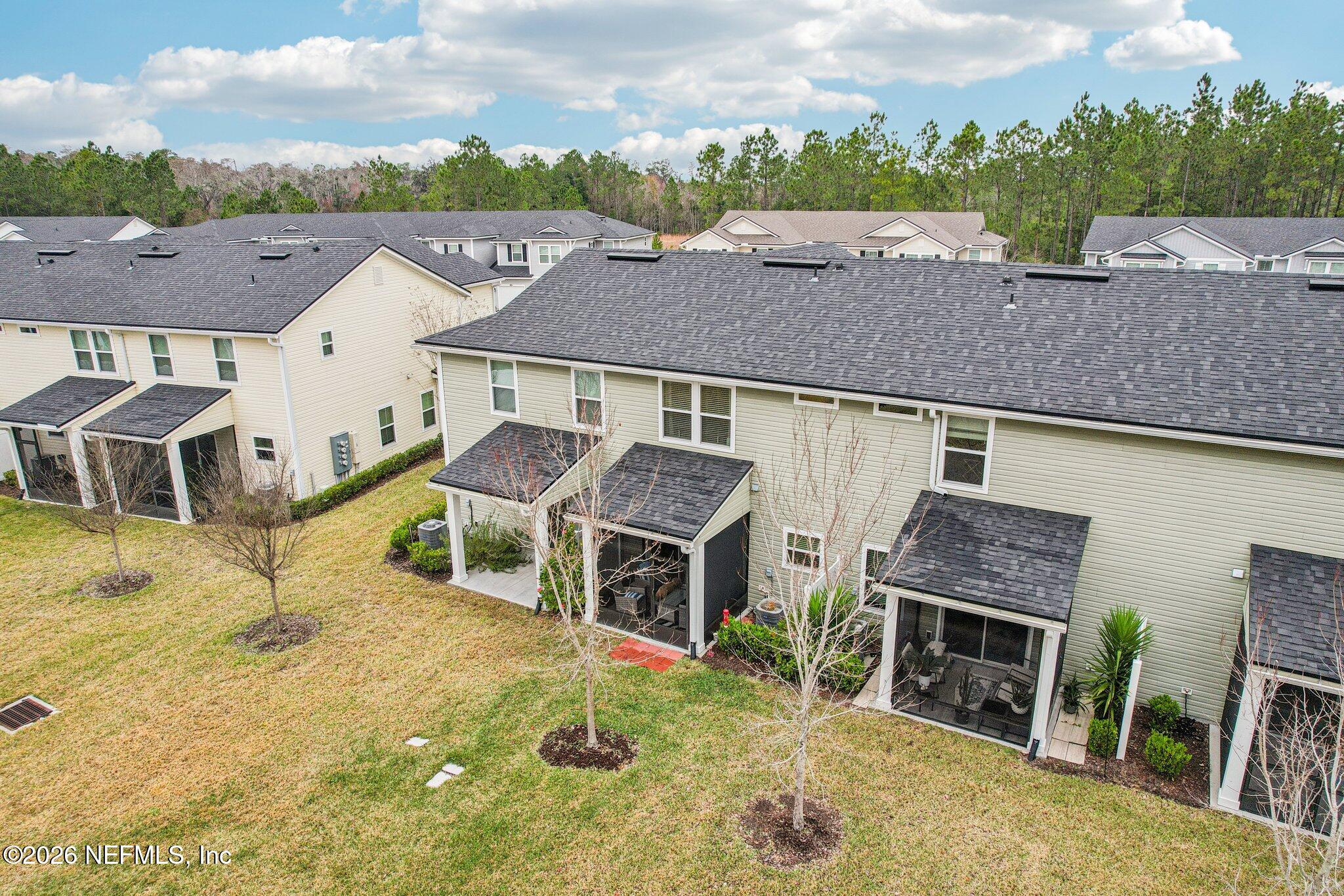 12068 Calvesta Street Jacksonville, FL 32256 - Photo 39 of 100 a aerial view of a house with a big yard and large tree