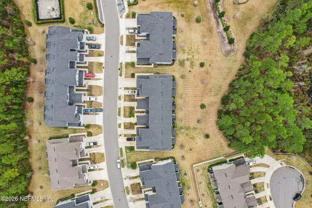 a view of pool with table and chairs under an umbrella
