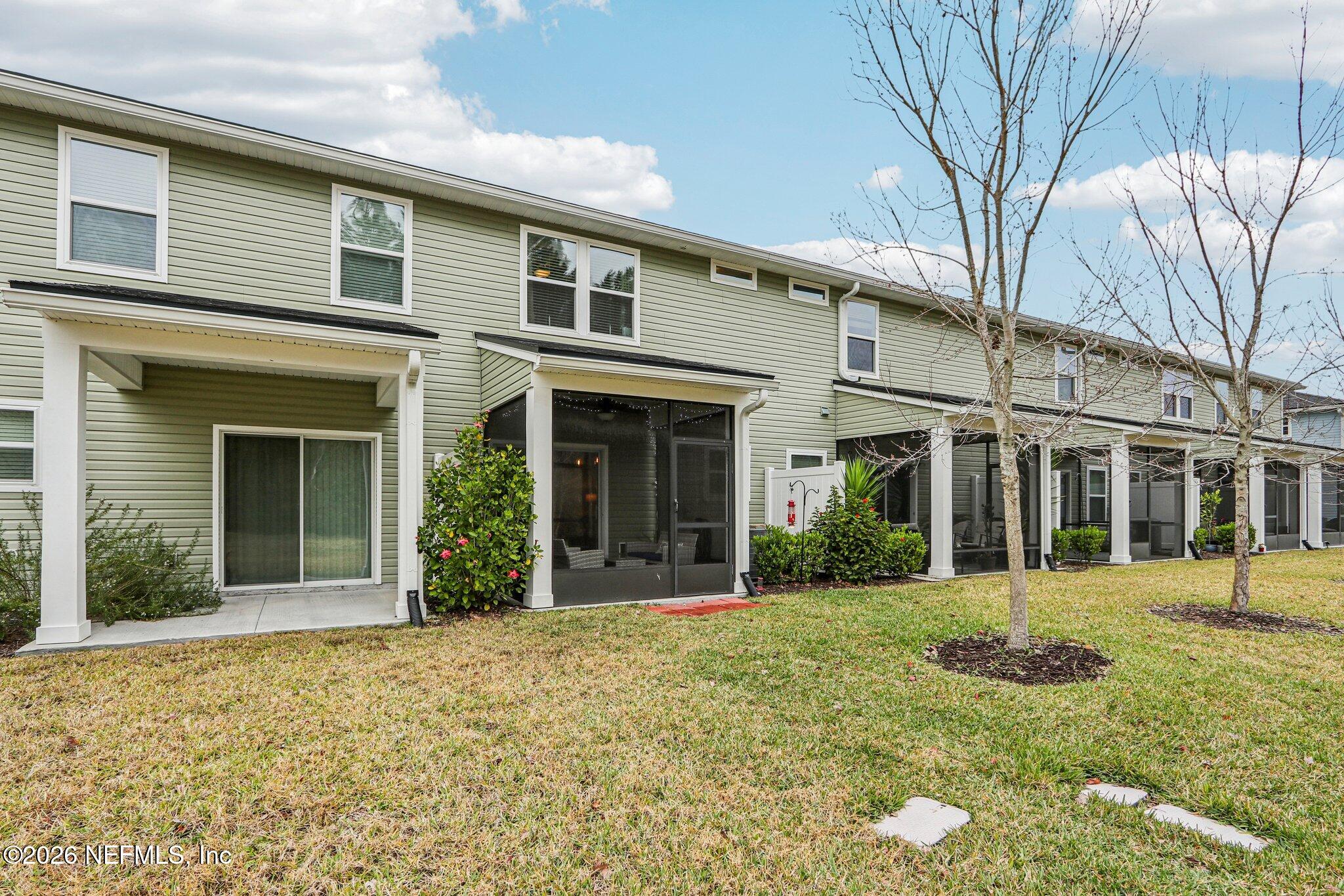 12068 Calvesta Street Jacksonville, FL 32256 - Photo 51 of 100 front view of a brick house with a yard