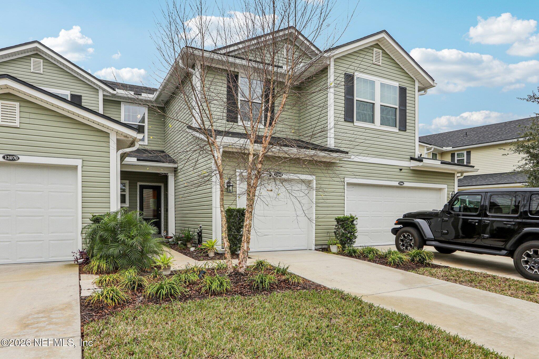 12068 Calvesta Street Jacksonville, FL 32256 - Photo 54 of 100 a front view of a house with a yard