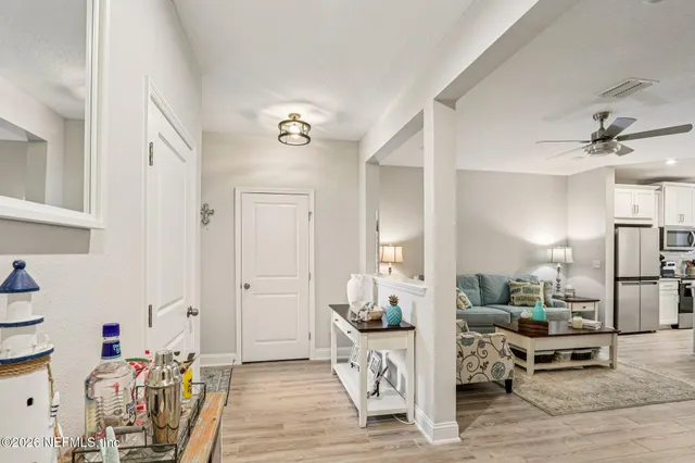 a kitchen with a sink a stove a dining table and chairs