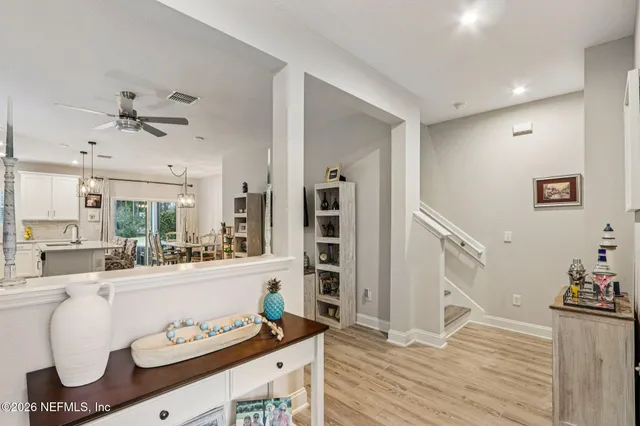 a kitchen with stainless steel appliances kitchen island granite countertop a sink a stove a refrigerator and cabinets