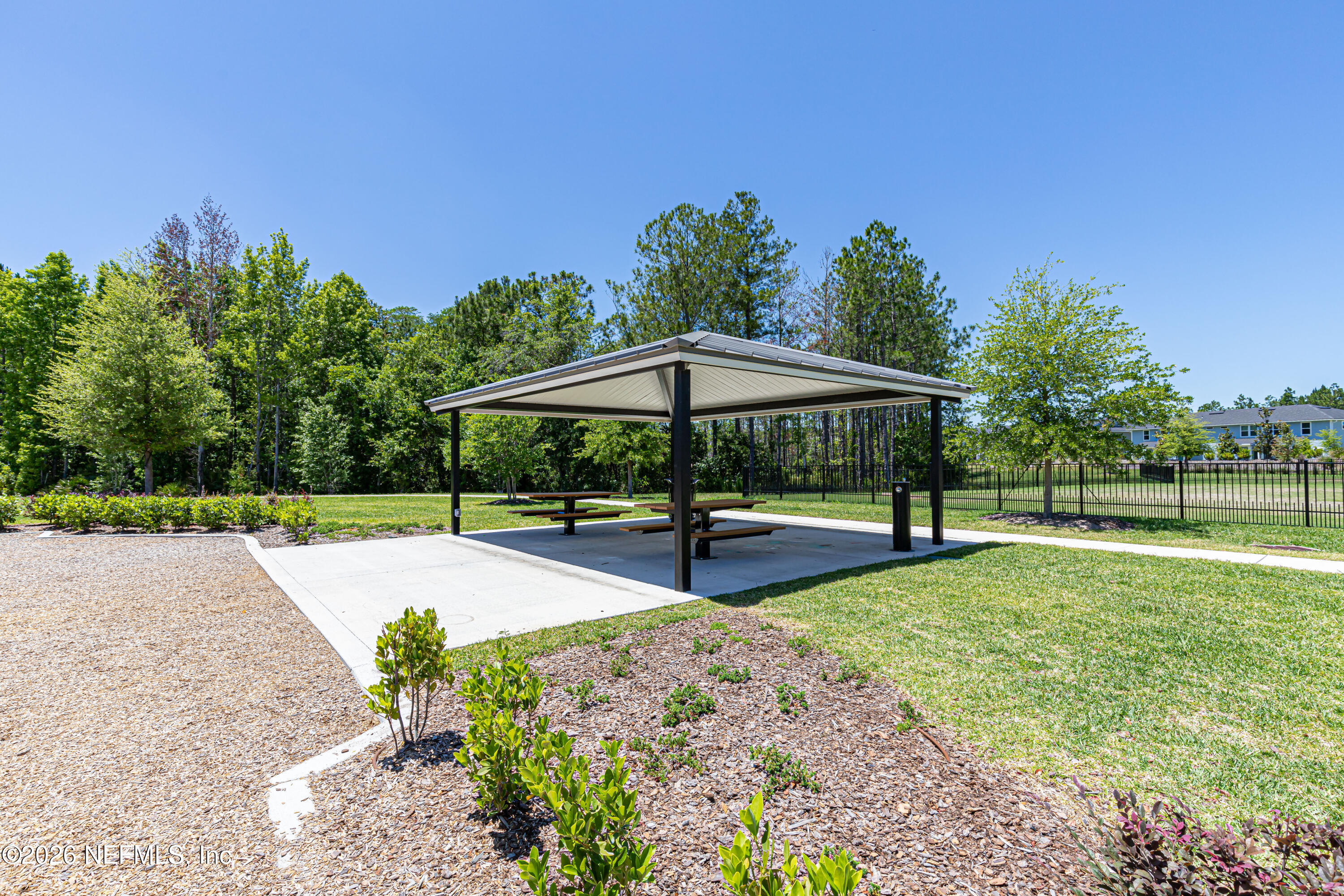 12068 Calvesta Street Jacksonville, FL 32256 - Photo 98 of 100 a view of pool with table and chairs under an umbrella