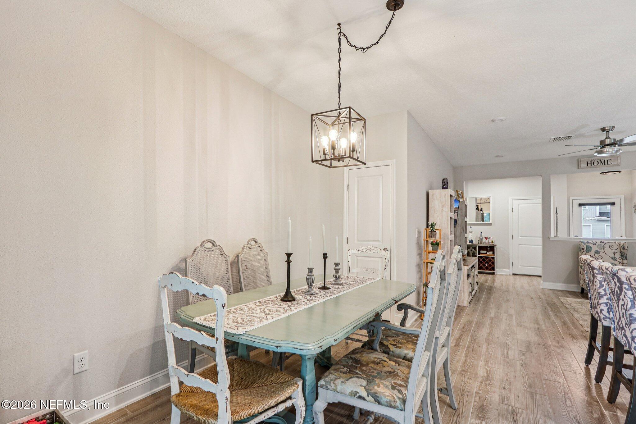 12068 Calvesta Street Jacksonville, FL 32256 - Photo 10 of 100 a view of a dining room with furniture and wooden floor