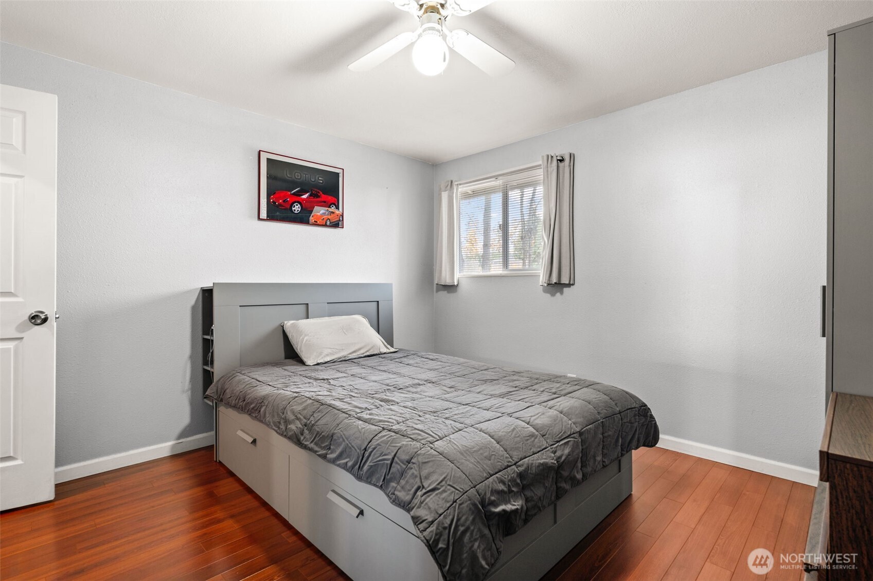 19234 121st Place Southeast Kent, WA 98031 - Photo 13 of 37 a bedroom with a large bed and a chandelier