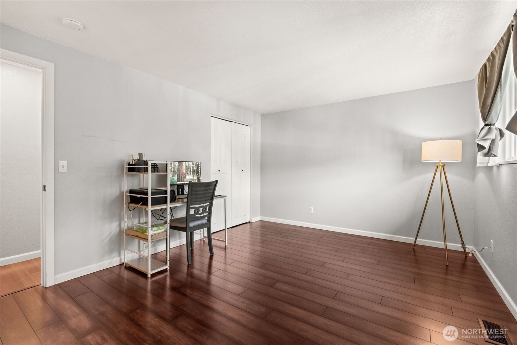 19234 121st Place Southeast Kent, WA 98031 - Photo 17 of 37 an empty room with wooden floor and chair