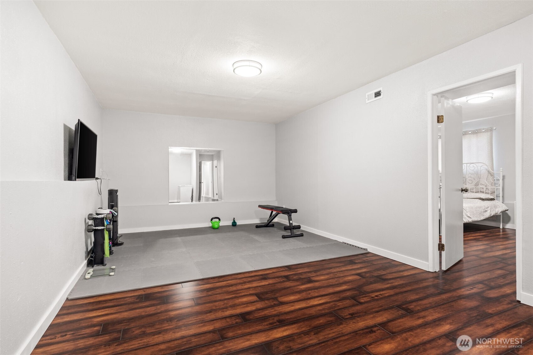 19234 121st Place Southeast Kent, WA 98031 - Photo 23 of 37 an empty room with wooden floor and a flat screen tv