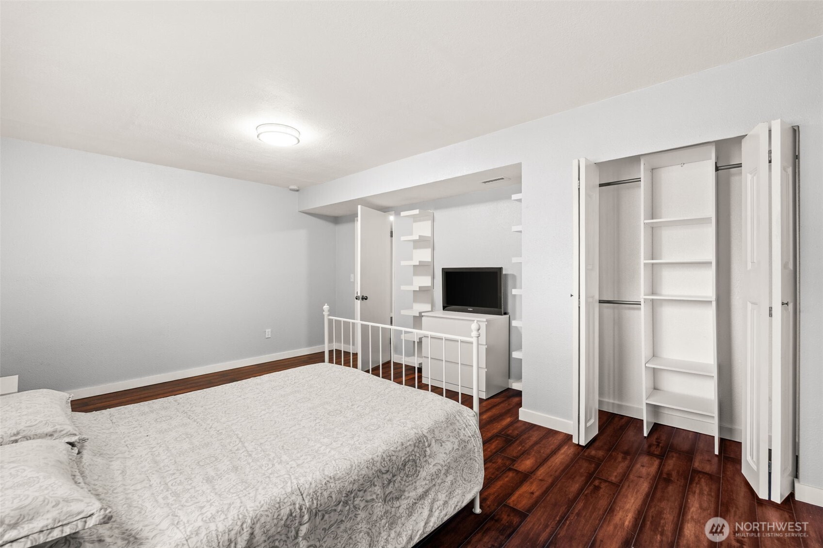 19234 121st Place Southeast Kent, WA 98031 - Photo 25 of 37 a bedroom with a bed and a flat screen tv