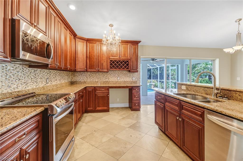 8116 Sandpiper Road Fort Myers, FL 33967 - Photo 13 of 29 Kitchen with appliances with stainless steel finishes, sink, an inviting chandelier, and pendant lighting