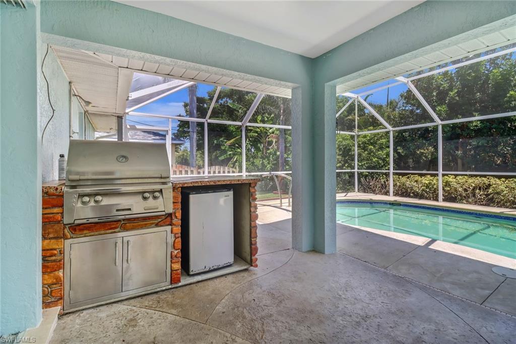 8116 Sandpiper Road Fort Myers, FL 33967 - Photo 22 of 29 View of swimming pool with grilling area, a lanai, and a patio area