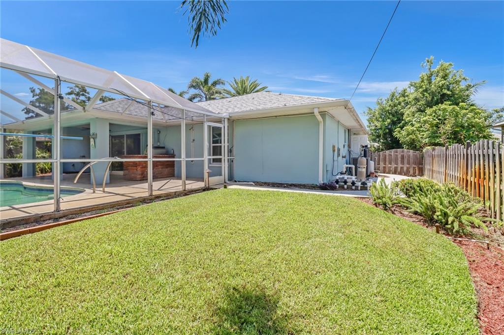 8116 Sandpiper Road Fort Myers, FL 33967 - Photo 29 of 29 View of yard featuring a lanai, a patio area, and Screened Lanai and pool