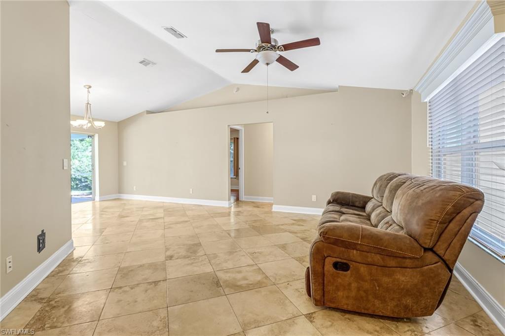 8116 Sandpiper Road Fort Myers, FL 33967 - Photo 9 of 29 Sitting room with lofted ceiling, light tile floors, and ceiling fan with notable chandelier