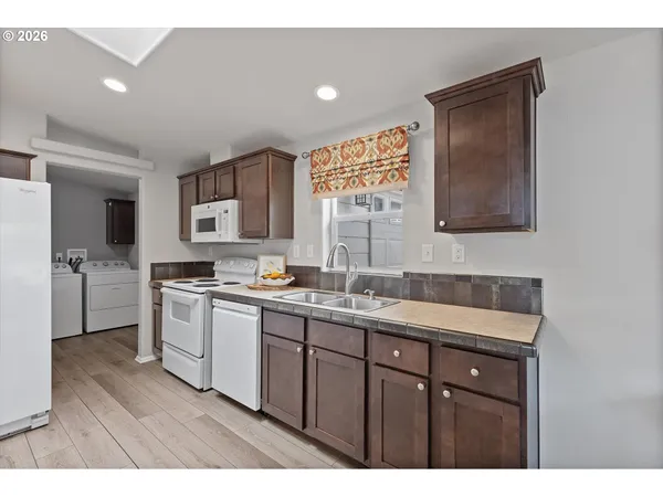 a kitchen with a refrigerator and a sink