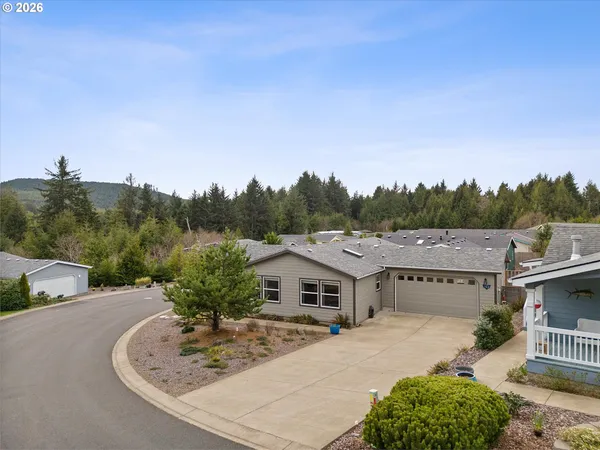 a living room with furniture floor to ceiling window and wooden floor