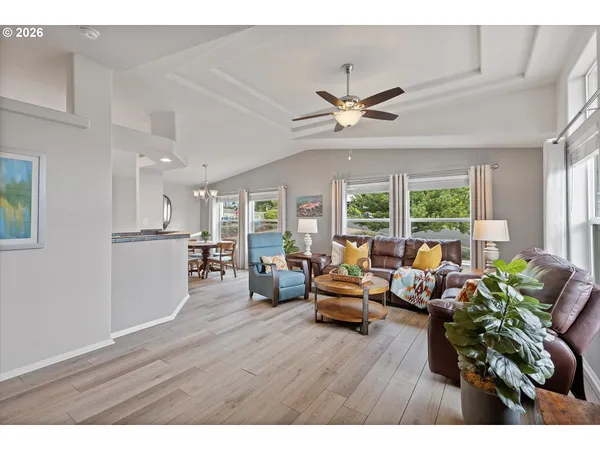 a living room with furniture wooden floor and a window