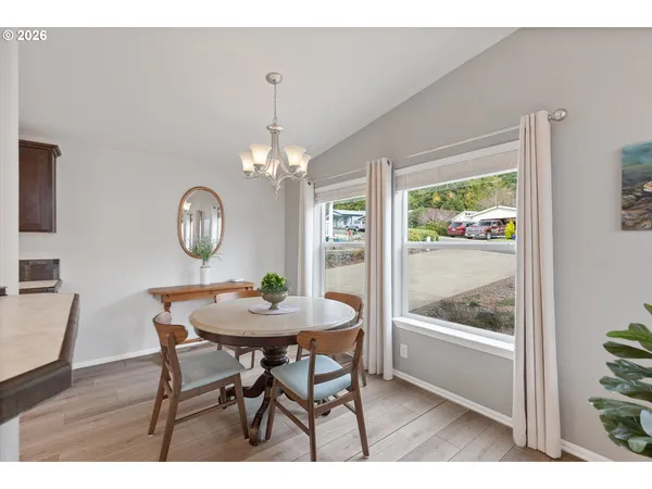 a kitchen with a sink cabinets and wooden floor