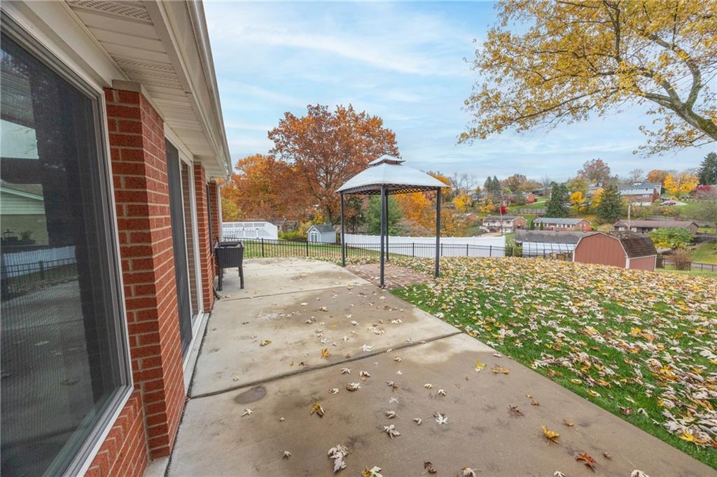 430 Amherst Avenue Coraopolis, PA 15108 - Photo 29 of 33 a view of a patio with a table chairs potted plants and a palm tree