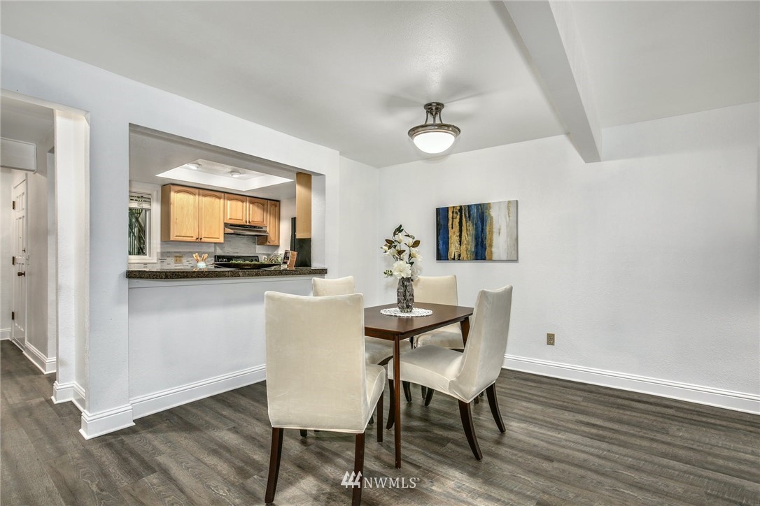 7571 Old Redmond Road, Unit 11 Redmond, WA 98052 - Photo 7 of 27 a view of a dining room with furniture and wooden floor