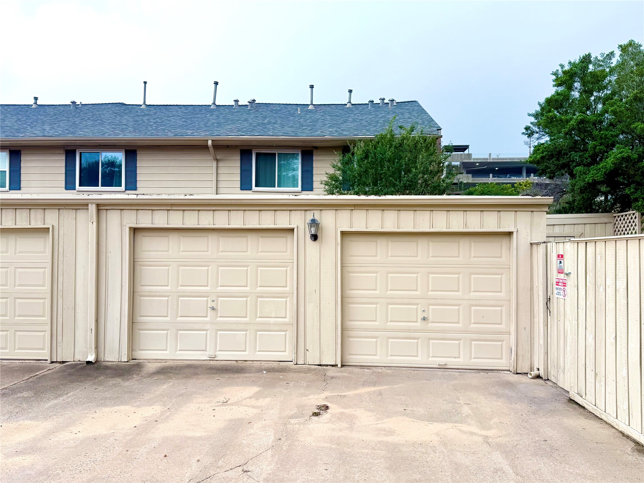 6452 Burgoyne Road, Unit 100 Houston, TX 77057 - Photo 34 of 44 a front view of a house with a garage