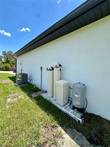 a view of a backyard with table and chairs and garden