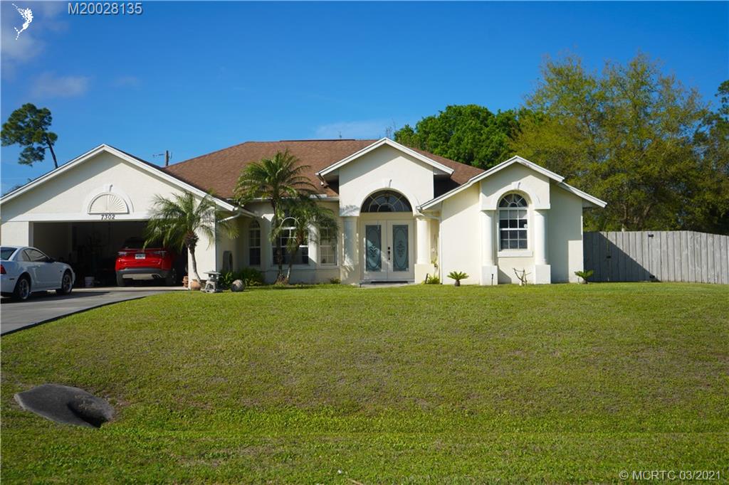 7302 Santa Rosa Parkway Fort Pierce, FL 34951 - Photo 4 of 33 a front view of a house with a garden