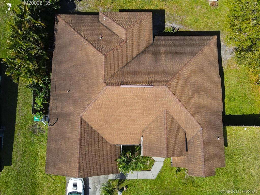 7302 Santa Rosa Parkway Fort Pierce, FL 34951 - Photo 7 of 33 an aerial view of a house with a yard and potted plants
