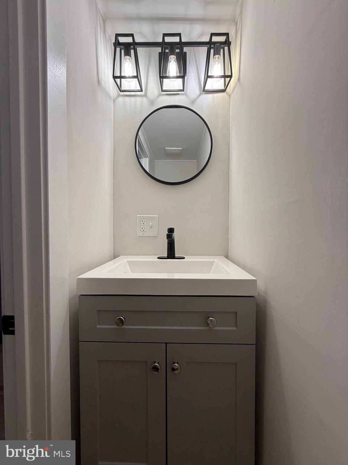 1263 South Merrimac Road Camden, NJ 08104 - Photo 5 of 16 a bathroom with a sink and a mirror