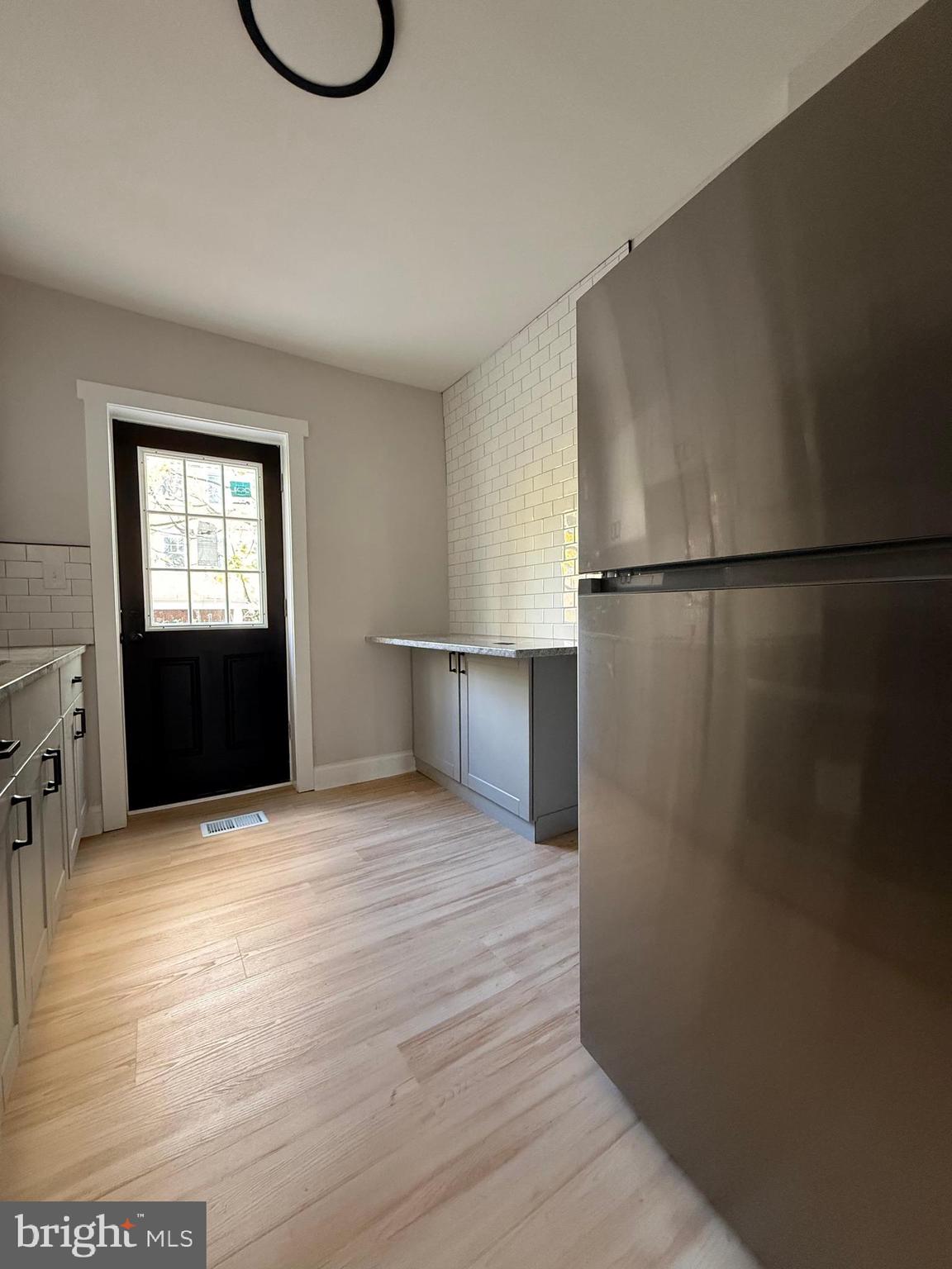 1263 South Merrimac Road Camden, NJ 08104 - Photo 8 of 16 a view of a kitchen with a refrigerator and a stove