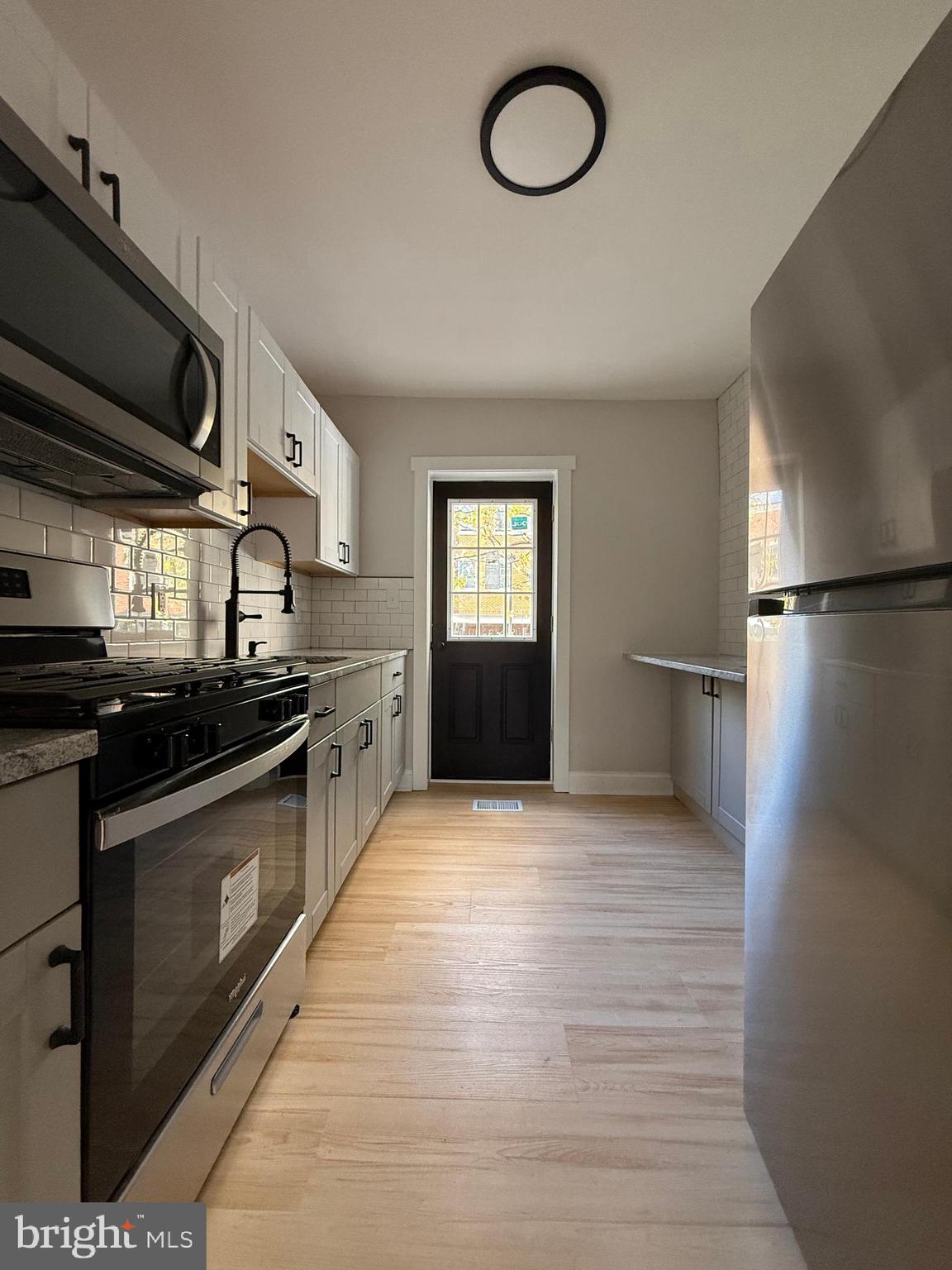 1263 South Merrimac Road Camden, NJ 08104 - Photo 9 of 16 a kitchen with stainless steel appliances granite countertop a refrigerator a sink dishwasher a stove and a refrigerator