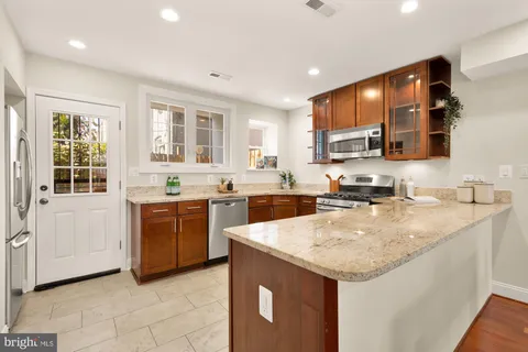 a kitchen with sink a microwave and cabinets