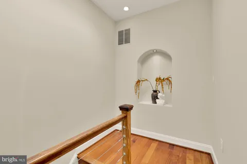 a bedroom with bed and wooden floor