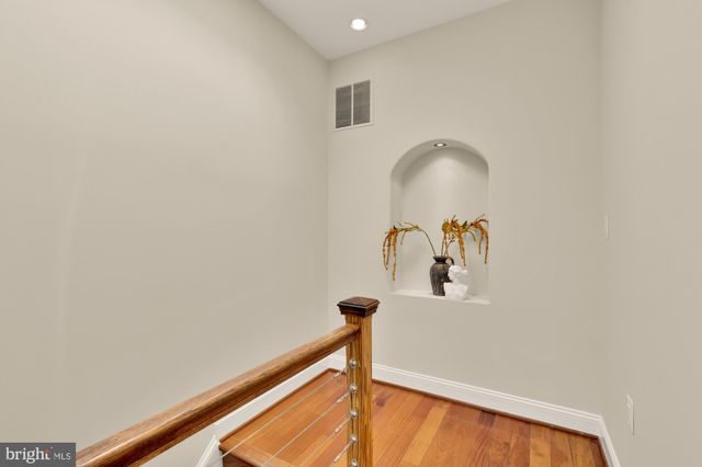 a bedroom with bed and wooden floor