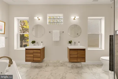 a bathroom with a bathtub sink and a mirror