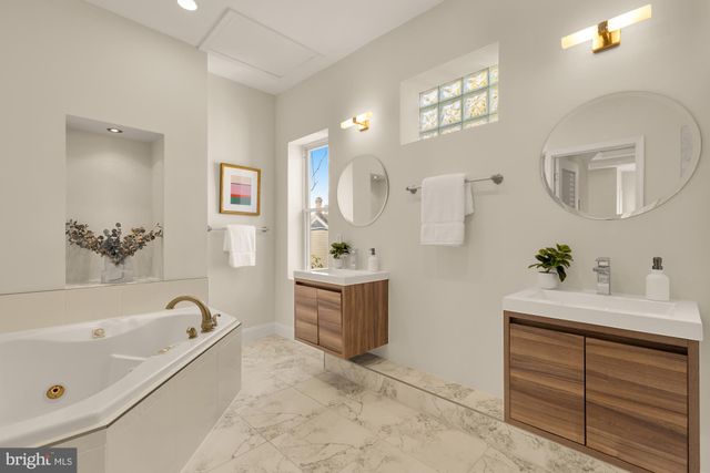a view of kitchen with refrigerator and mirror