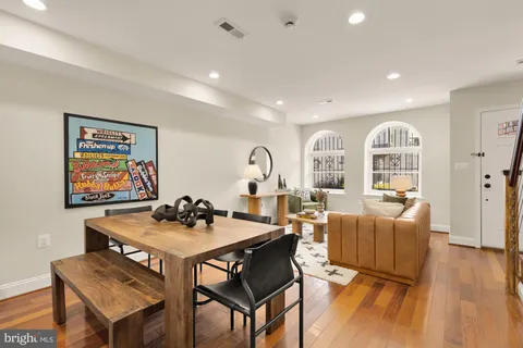 a dining room with furniture and wooden floor