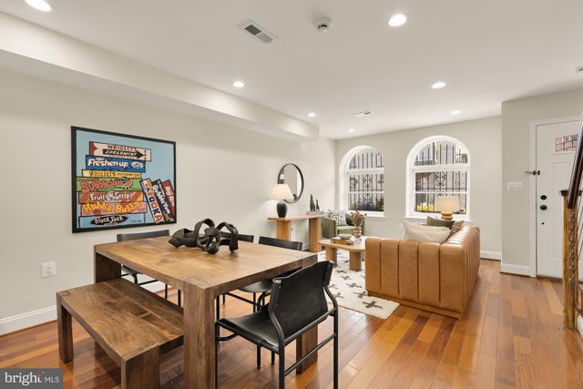 a dining room with furniture and wooden floor
