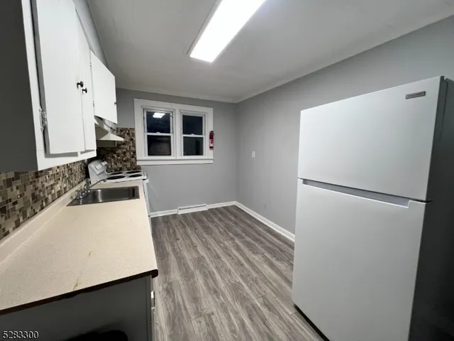 a kitchen with a refrigerator and a sink