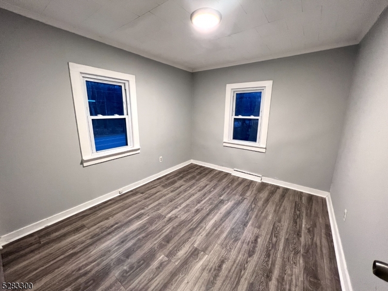 13 Highway 206, Unit A Branchville, NJ 07826 - Photo 7 of 8 a view of an empty room with wooden floor and a window