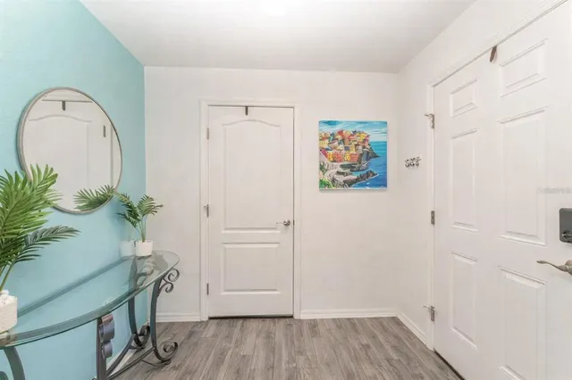 an entryway with wooden floor