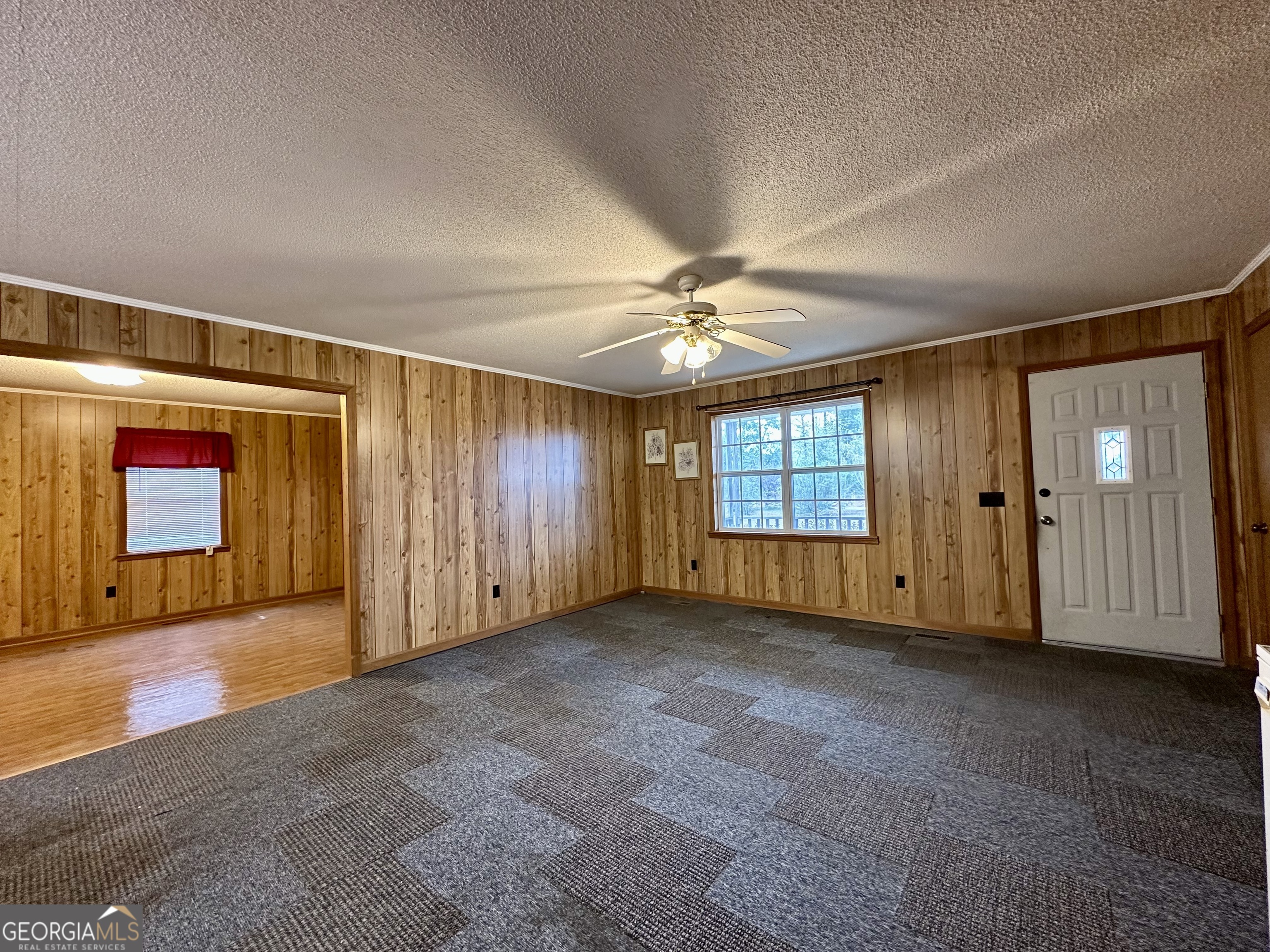 74 Community Church Road McRae-Helena, GA 31037 - Photo 9 of 31 an empty room with windows and chandelier fan