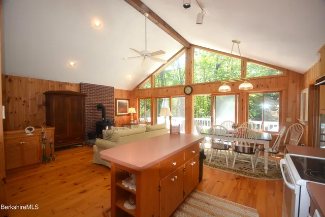 a view of a dining room with furniture a chandelier and wooden floor