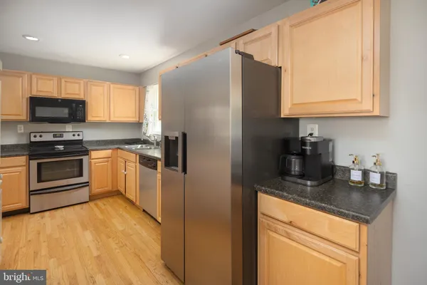 a kitchen with a refrigerator sink and microwave