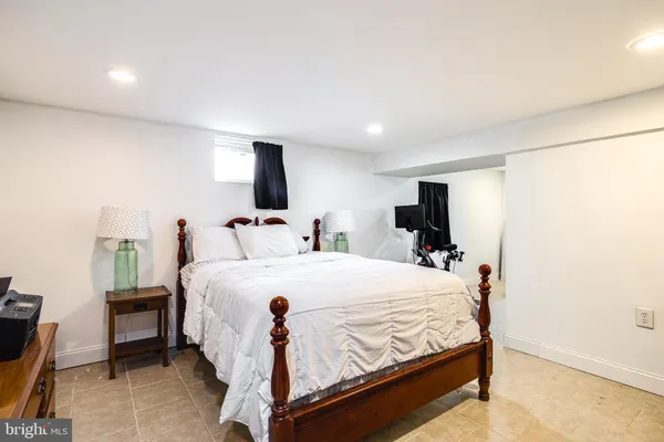 a large bedroom with bed and window