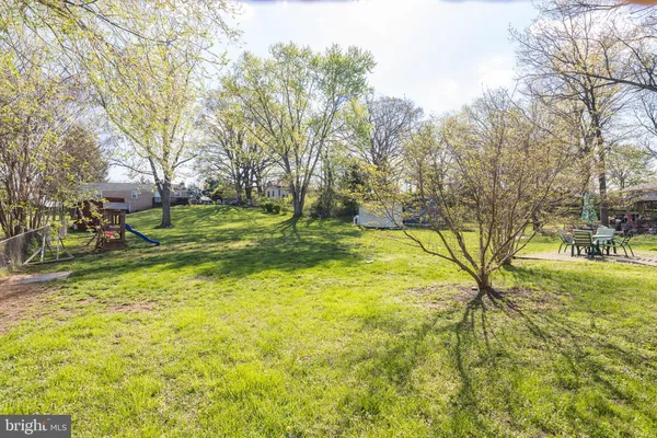 a view of yard with swimming pool and green space