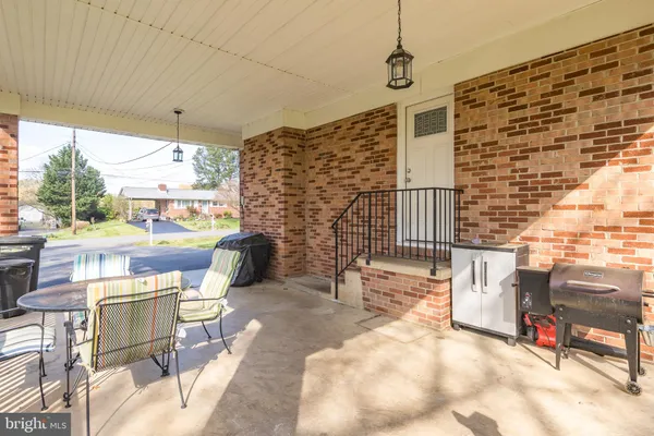 a view of a chairs and table in a patio