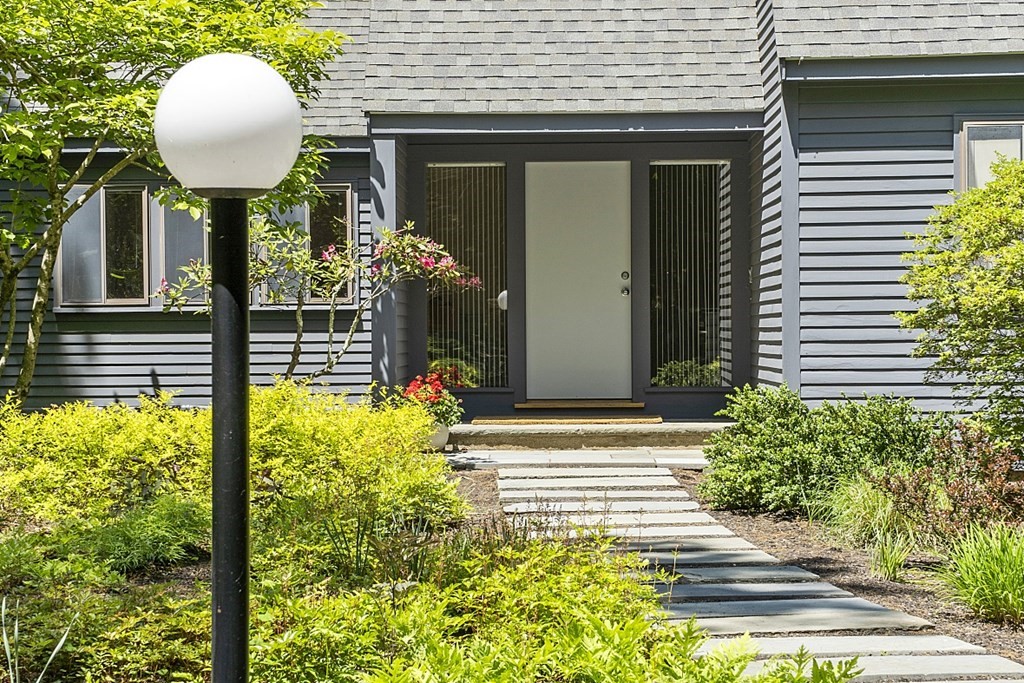 70 Davison Drive Lincoln, MA 01773 - Photo 3 of 37 a front view of a house with garden