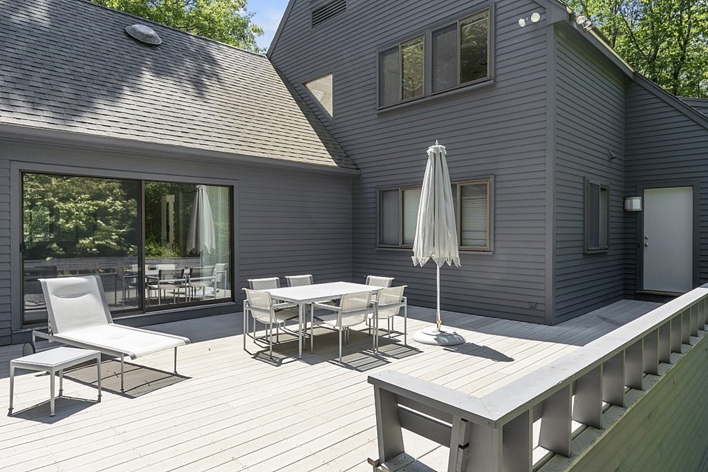 70 Davison Drive Lincoln, MA 01773 - Photo 32 of 37 a view of a patio with table and chairs with wooden floor and fence